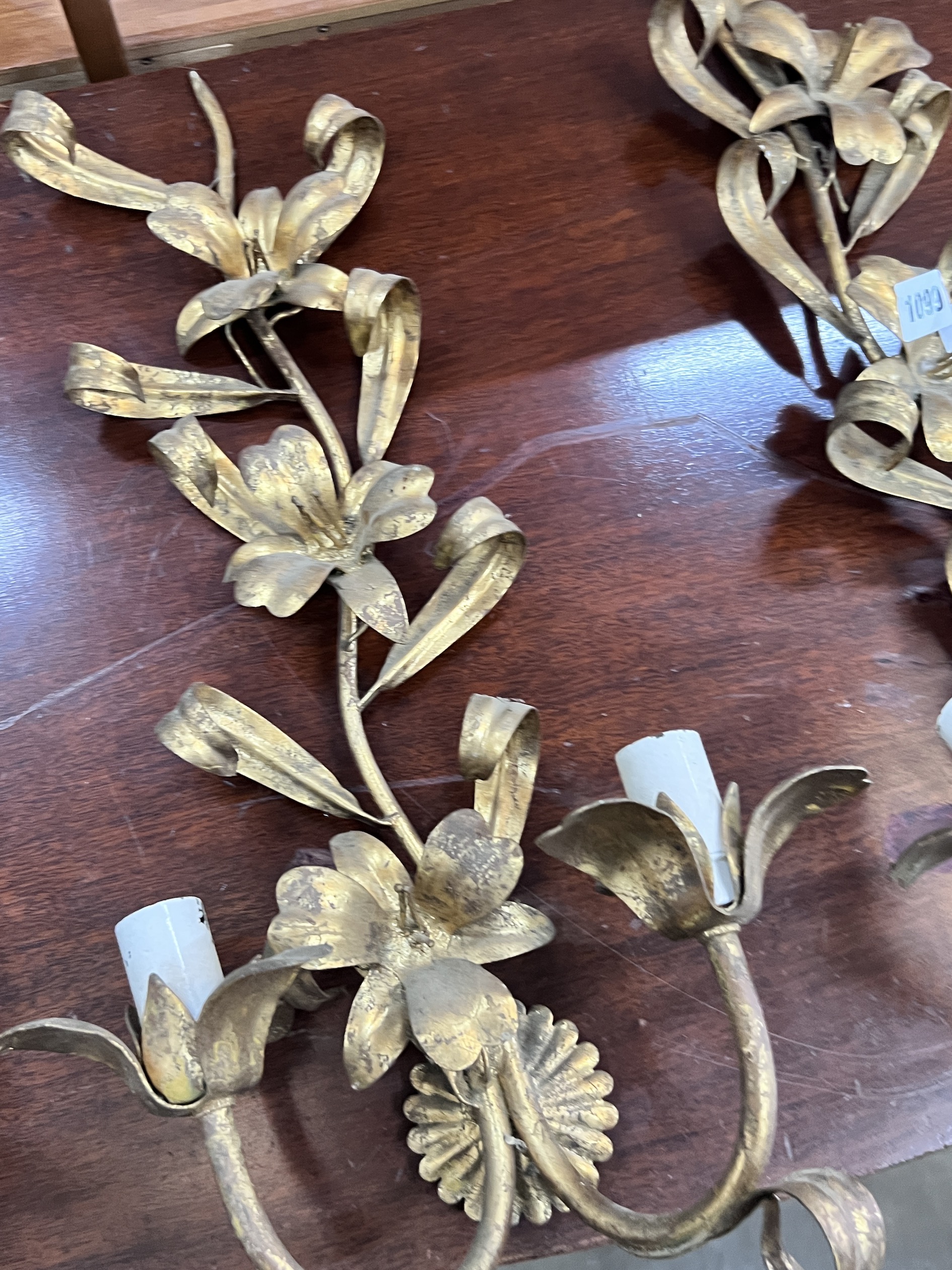 A set of three gilt metal floral two branch wall lights